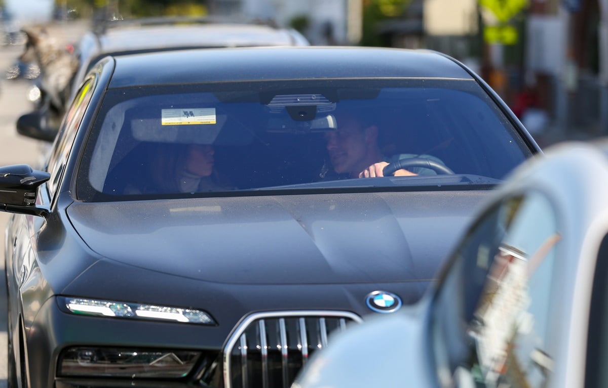 Ben Affleck and Jennifer Lopez driving around Los Angeles in a black car.