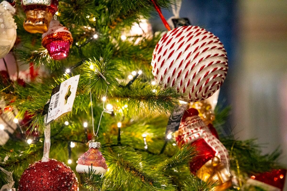 A red and white Christmas ornament on a tree