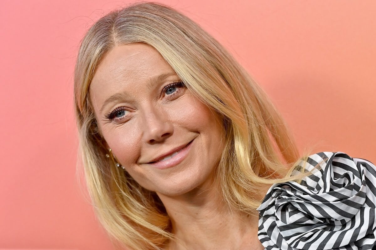 Gwyneth Paltrow posing in a black and white outfit at the Veuve Clicquot Celebrates 250th Anniversary with Solaire Exhibition.