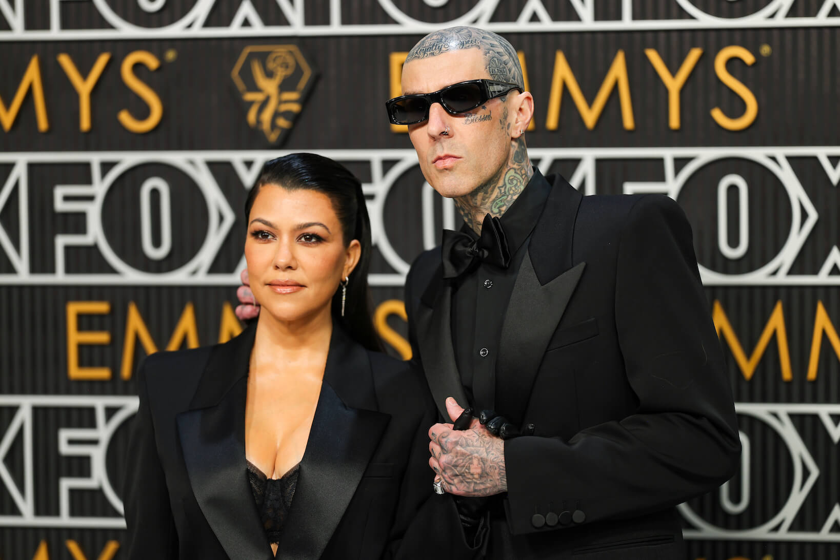 Kourtney Kardashian and Travis Barker dressed in black at the Emmys in 2024