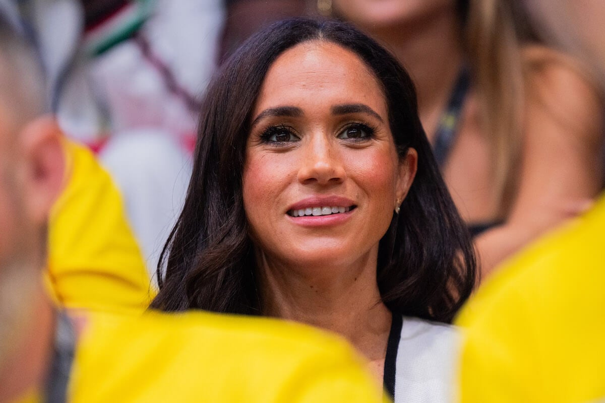 Meghan Markle, who may appear on 'Real Housewives' visiting a celebrity friend, looks on