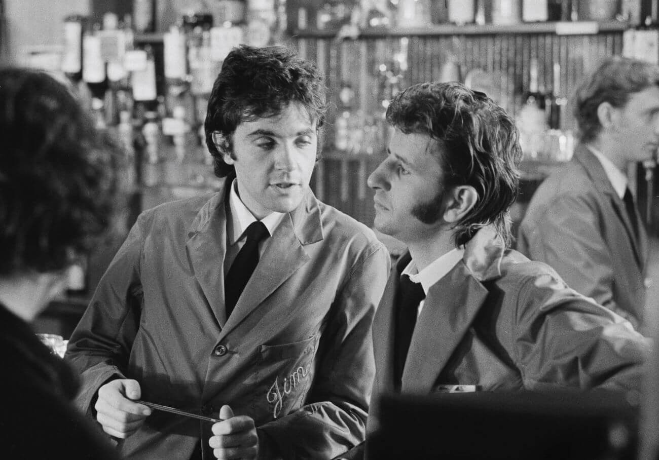 A black and white picture of David Essex and Ringo Starr wearing matching outfits on the set of 'That'll Be the Day'