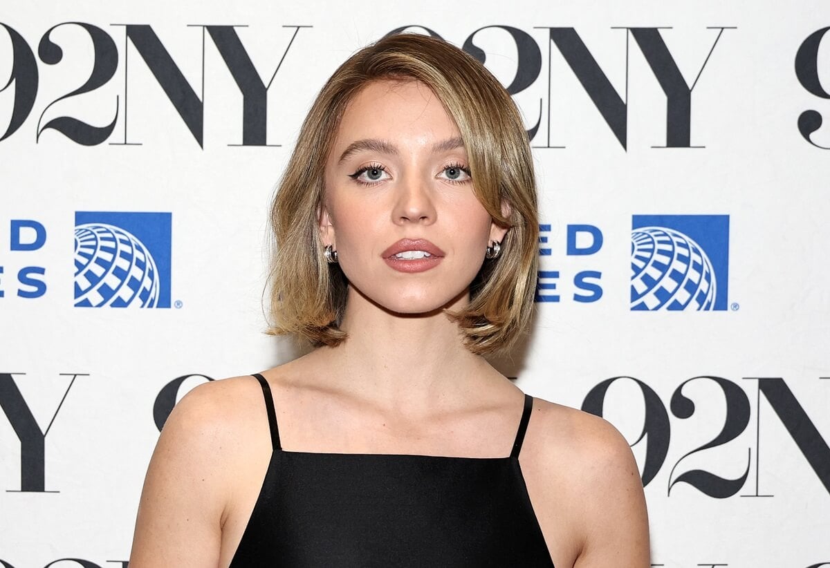 Sydney Sweeney posing at Sydney Sweeney In Conversation With Josh Horowitz in a black dress.