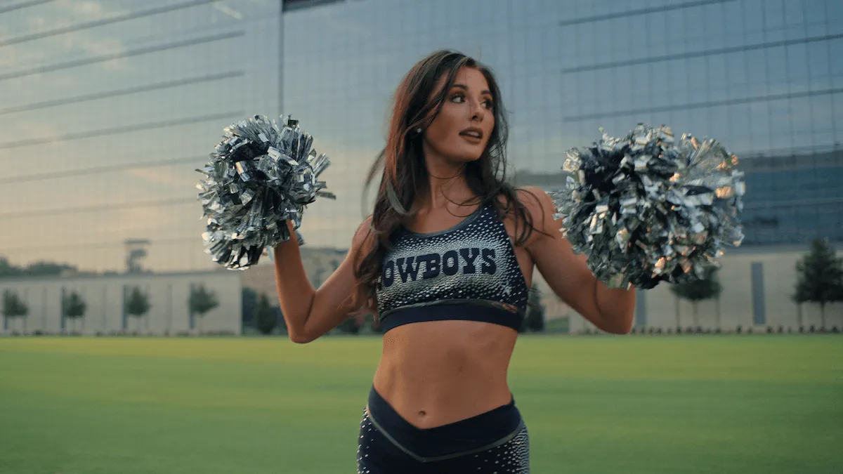 Dallas Cowboys Cheerleader holding poms