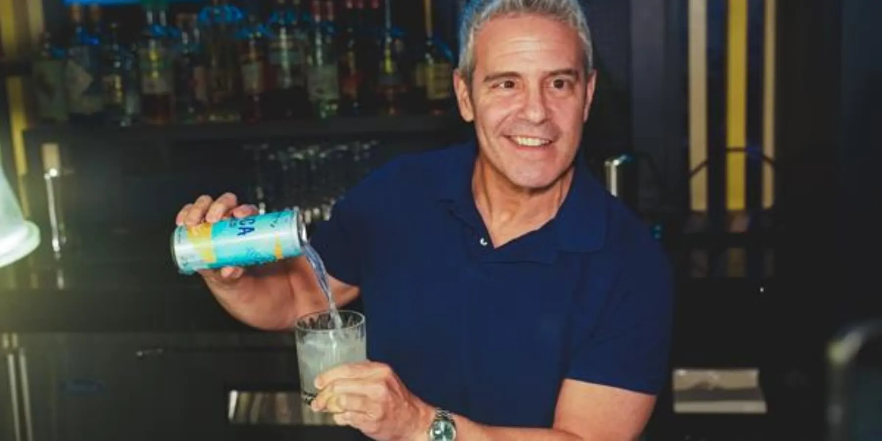 Andy Cohen pours a can of Fresca Mixed