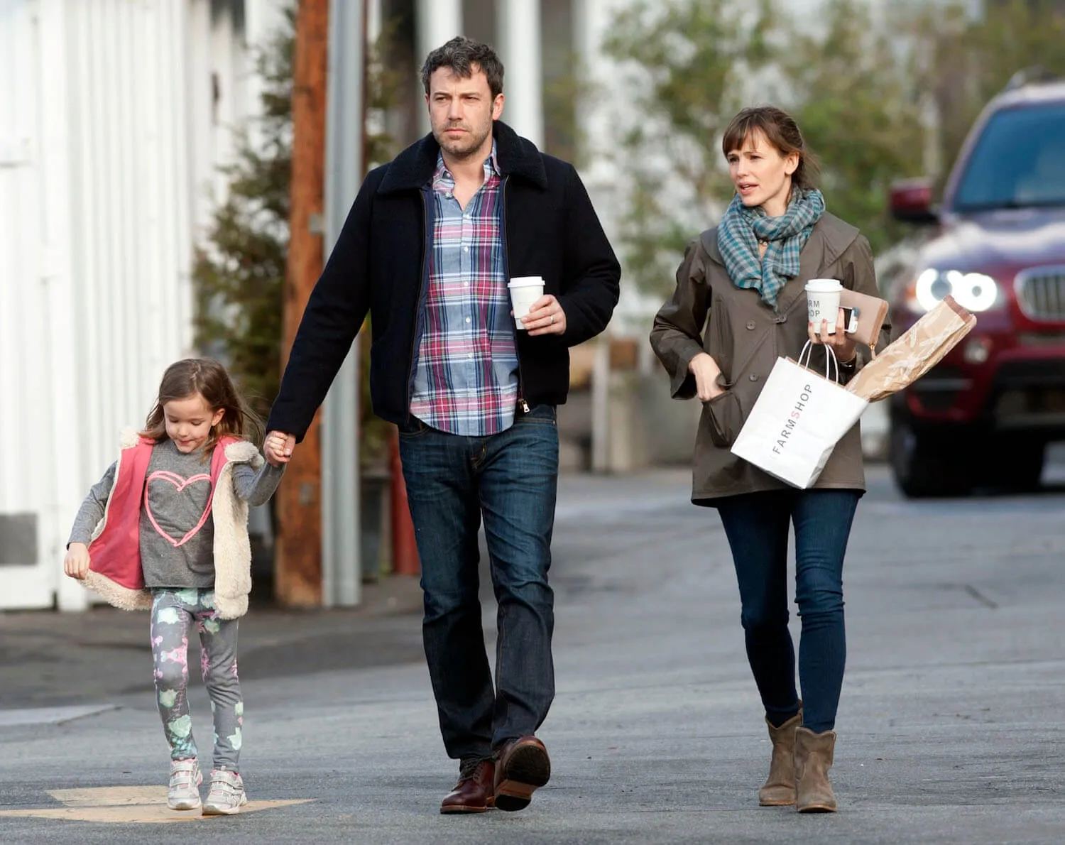 Ben Affleck and Jennifer Garner walk with their child, Fin Affleck, down the street in Los Angeles in February 2014