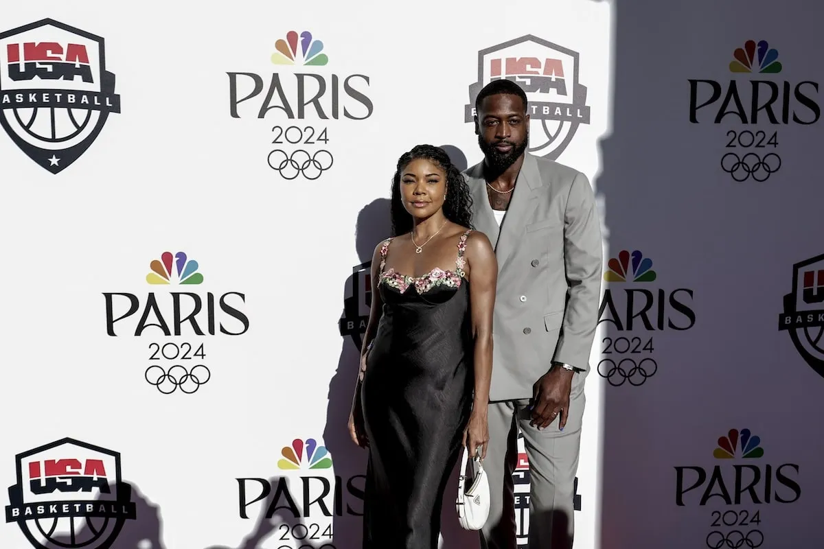 Wearing a black dress, Gabrielle Union stands with Dwyane Wade at NBA's Celebration of US Basketball in the Paris 2024 Olympics