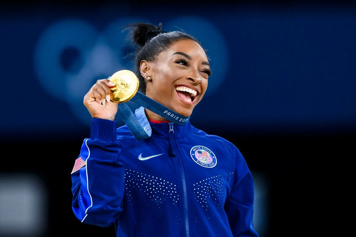 Gold mealist Simone Biles of Team United States celebrates on the podium during the medal ceremony