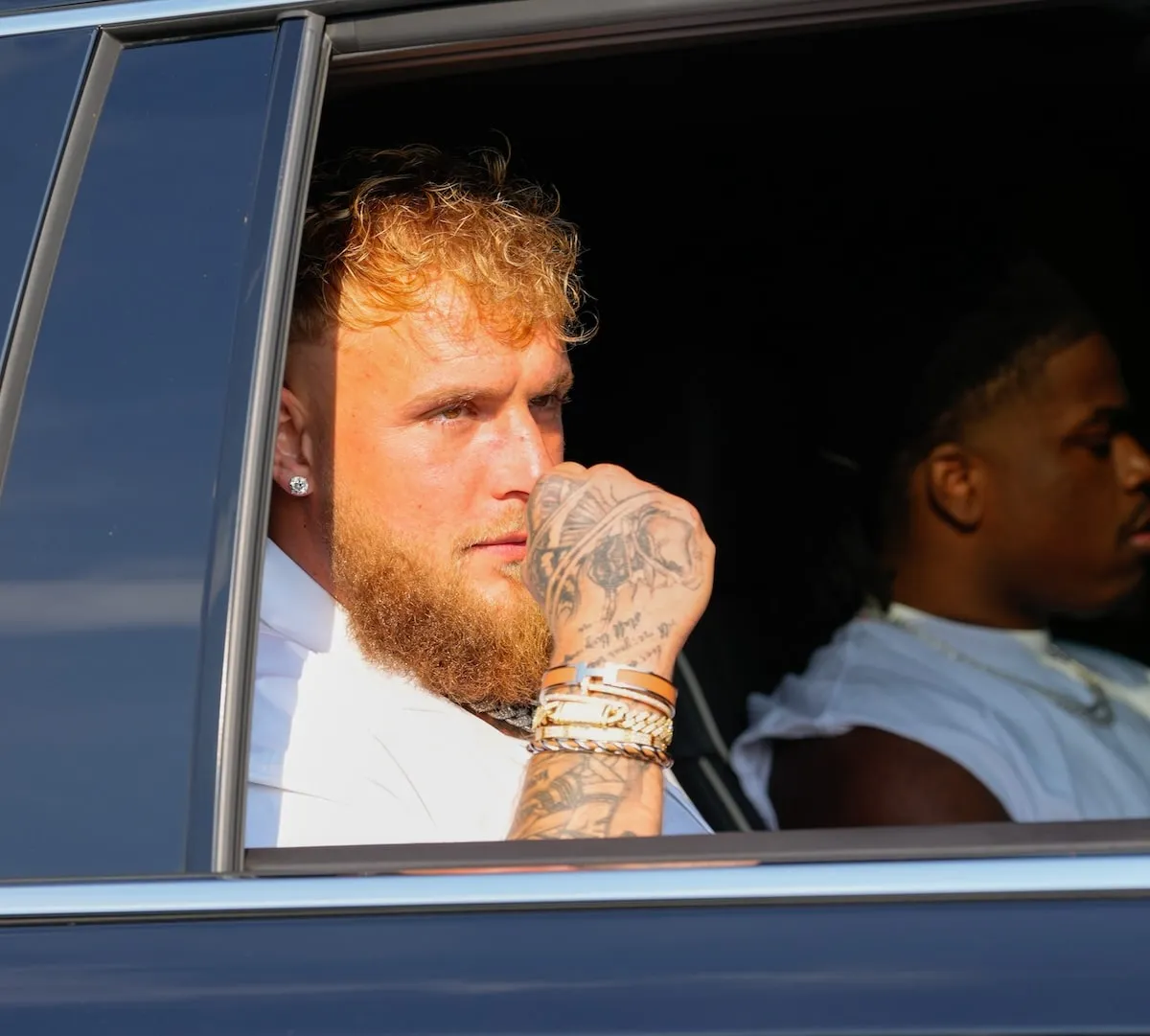 Youtuber Jake Paul looks out the rolled down window of his car