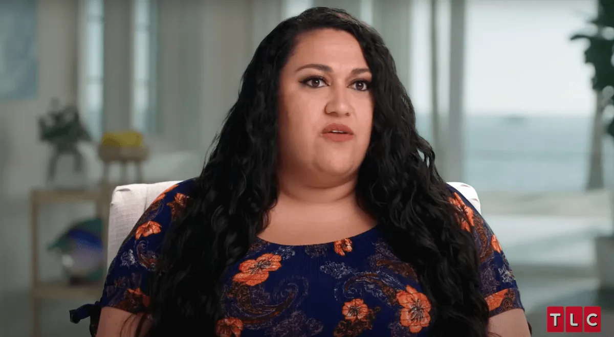 Kalani Faagata of 90 Day Fiancé wearing a floral print top