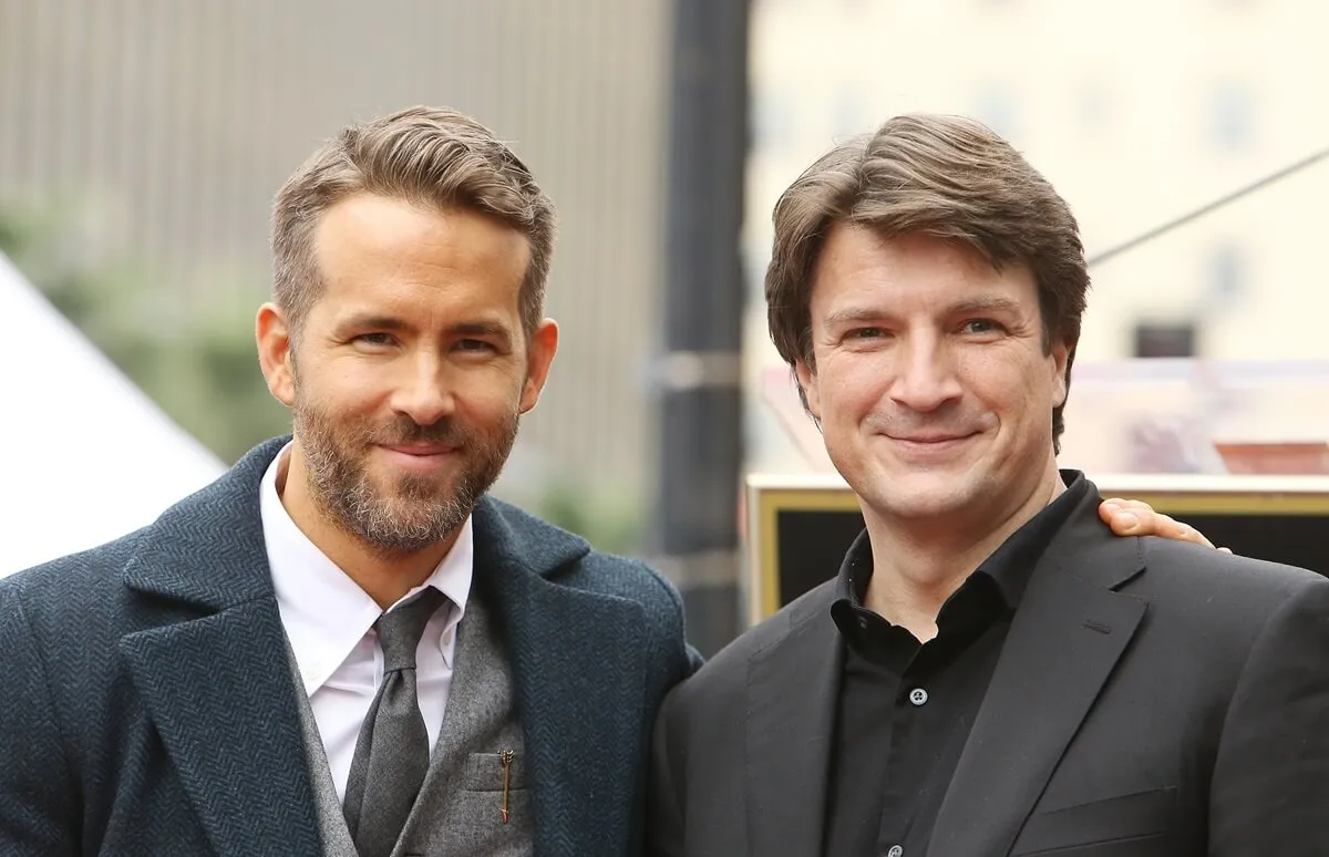 Ryan Reynolds and Nathan Fillion posing at Reynolds' Hollywood Walk of Fame ceremony.