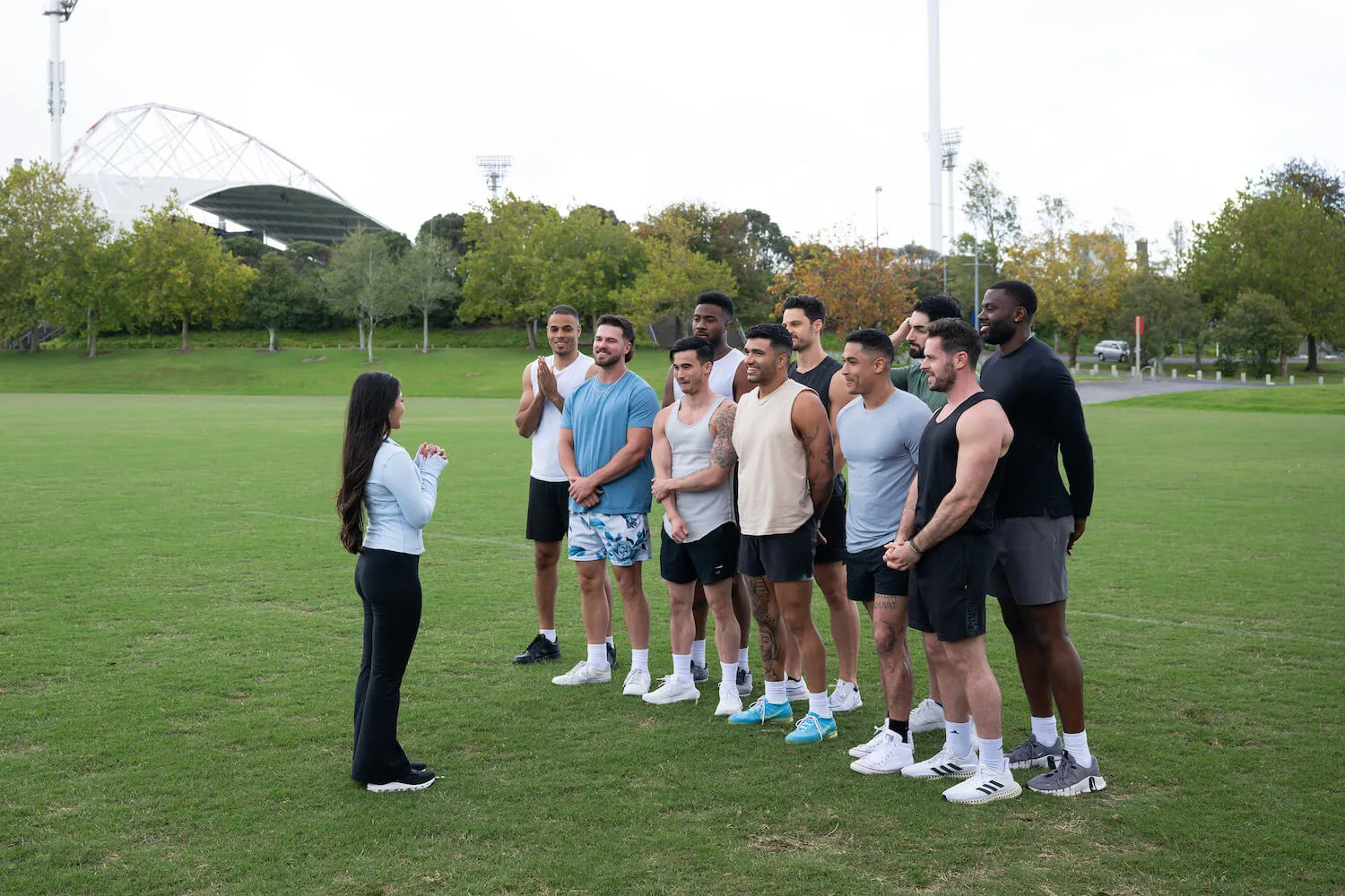 Jenn Tran speaking to her men on a field during a group date in 'The Bachelorette' Season 21